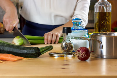 Midsection of man preparing food on table