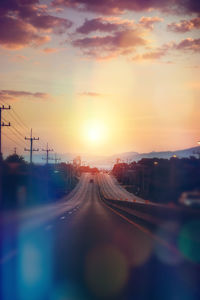 Railroad tracks against sky during sunset