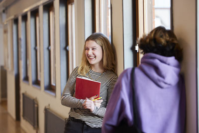 Teenage girls talking at corridor