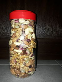 Close-up of glass jar on table against wall