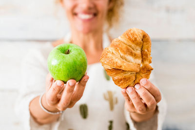 Midsection of woman holding fruit