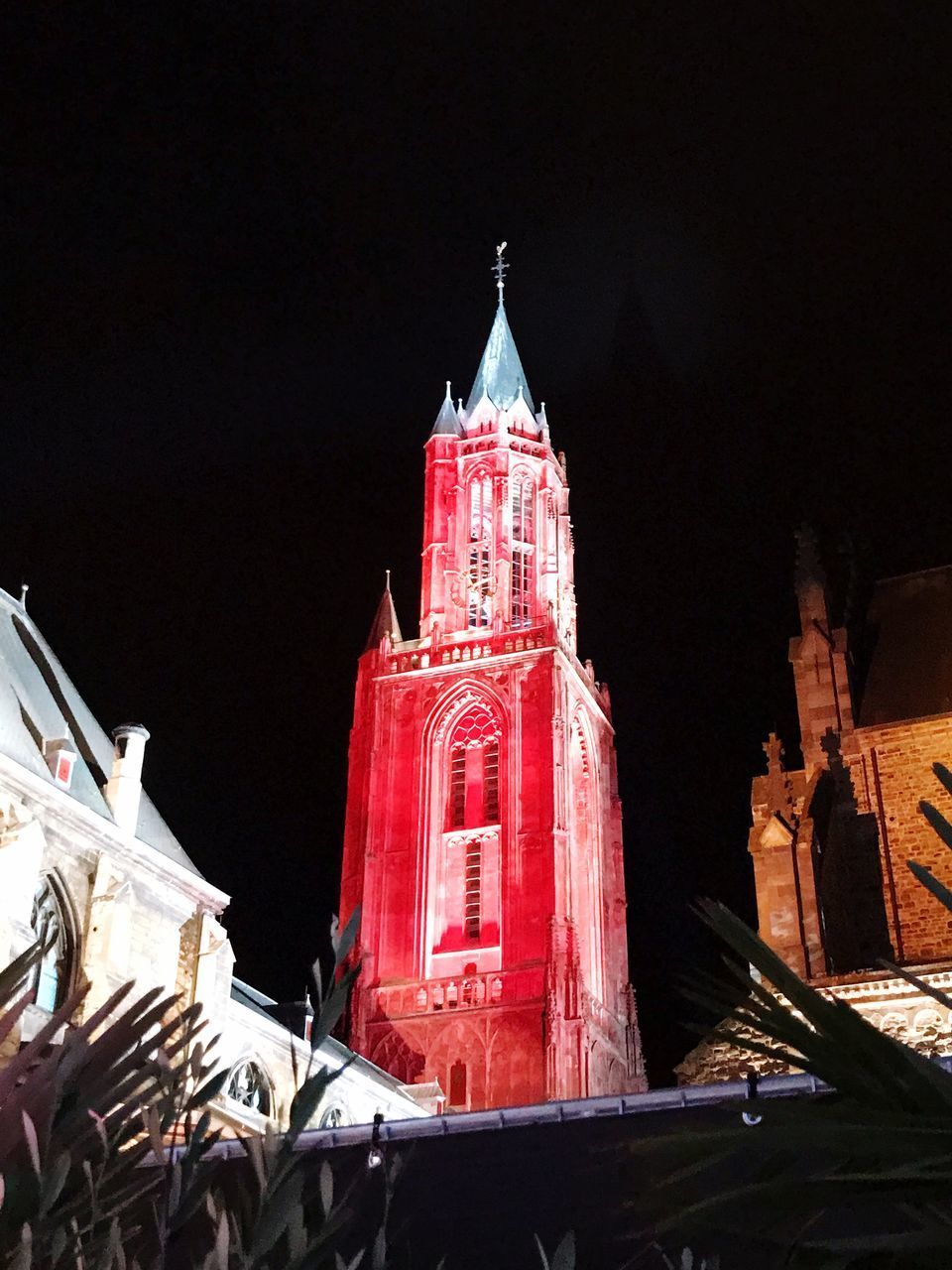 LOW ANGLE VIEW OF ILLUMINATED BUILDINGS AT NIGHT