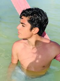 Shirtless young man in sea