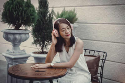 Portrait of young woman using mobile phone at home