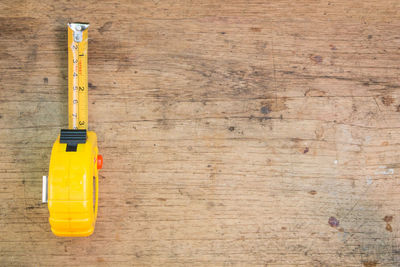 Directly above shot of yellow ruler on table