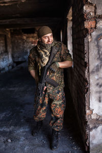 Low angle view of man standing against wall