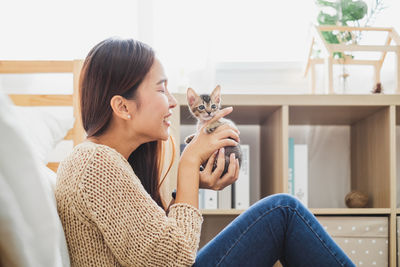 Young woman sitting on sofa at home