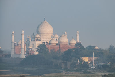 Taj mahal seen in the distance from agra fort at sunset, agra.