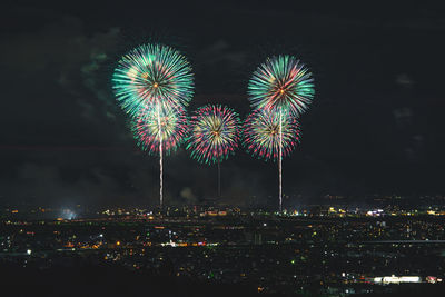 Low angle view of firework display at night