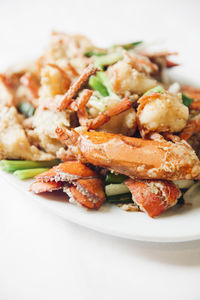 High angle view of food served in plate against white background