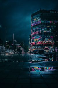 Illuminated city street and buildings at night