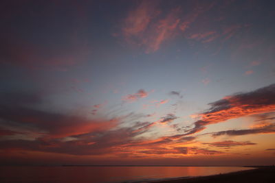 Scenic view of sea against romantic sky at sunset