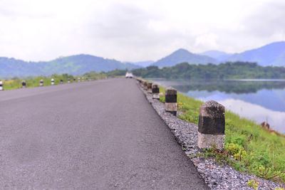 Road by mountain against sky