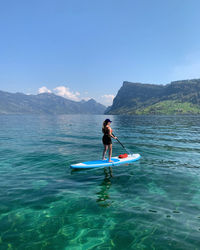 Man kayaking in sea