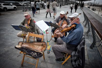 People sitting on chair in city