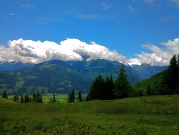 Scenic view of mountains against cloudy sky