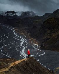 High angle view of young woman standing on mountain