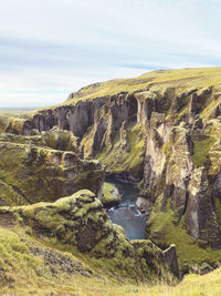 Scenic view of sea against sky iceland cliff river water fjord green grass holiday travel hiking