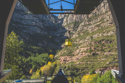 Overhead cable car against mountain