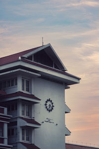 Low angle view of building against cloudy sky