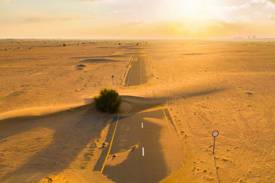 Scenic view of desert against sky during sunset