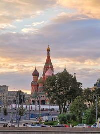 Buildings in city against sky during sunset