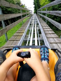 Low section of boy sitting in ride at amusement park ride