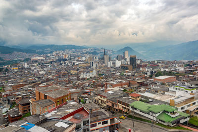 High angle view of cityscape against cloudy sky