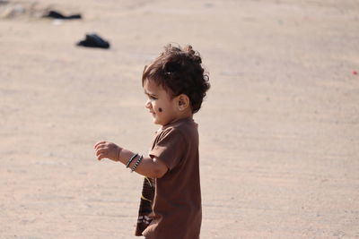 Full length of cute boy on beach,view of children running on send in summer ,meadow