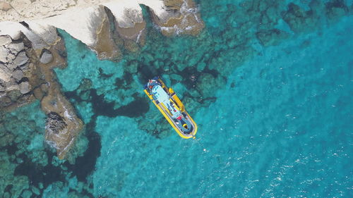 High angle view of people swimming in sea