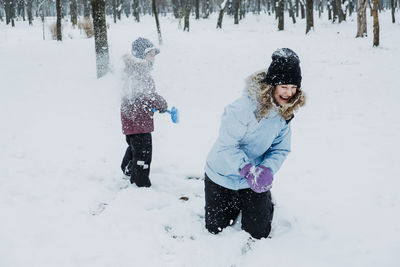 Outdoor winter activities for kids and family. let it snow. happy family mom and kid boy having fun