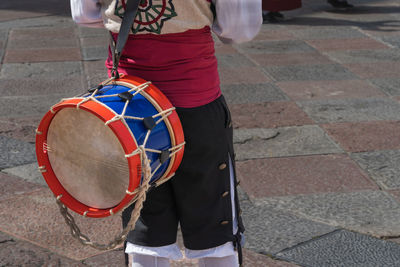 Midsection of drummer standing on street