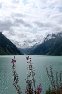 Scenic view of lake by mountains against sky