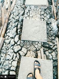 Low section of person standing on stone