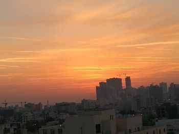 Cityscape against sky during sunset