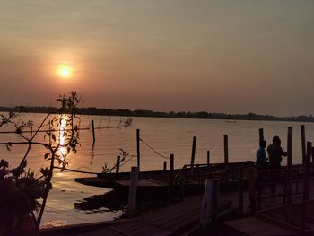 Silhouette pier on sea against sky during sunset