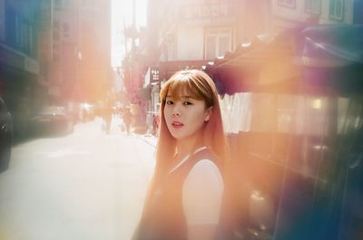 Portrait of young woman in city