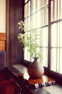 Close-up of flower vase on table at home