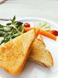 Close-up of burger and bread on plate