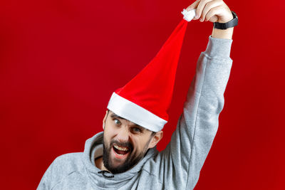 Portrait of man with red umbrella