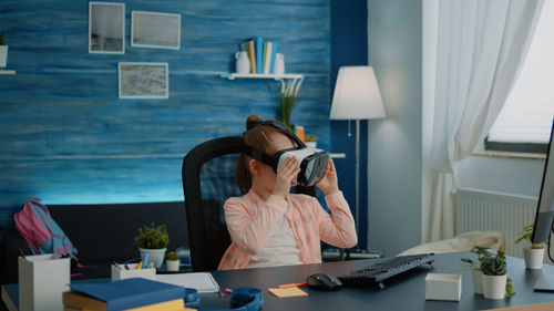 Girl using virtual reality simulator at home