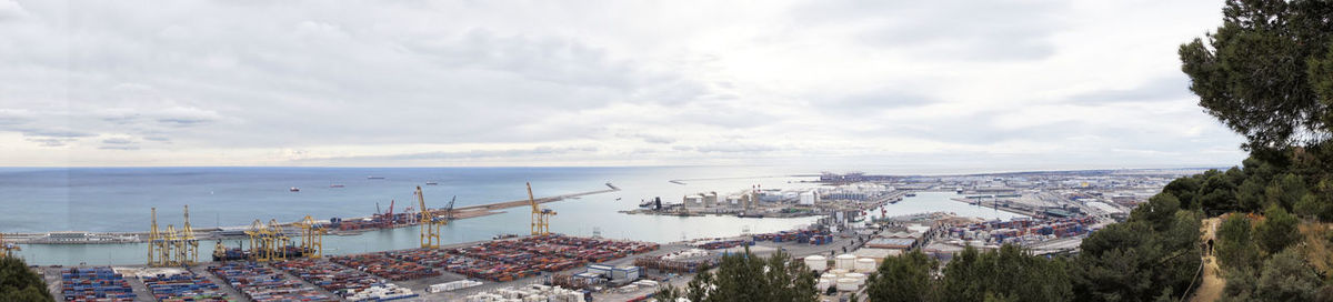 High angle view of city by sea against sky