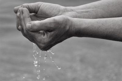 Close-up of hand splashing water