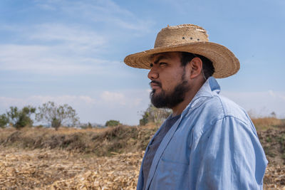 Farmer wearing hat standing on field