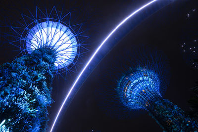 Low angle view of illuminated ferris wheel at night