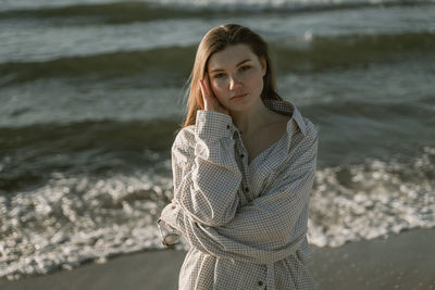 Portrait of young woman standing standing at beach