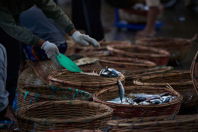 Buckets of fresh sardines fish at traditional seafood market, indonesia