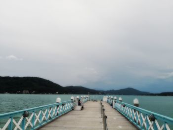 Pier over sea against sky