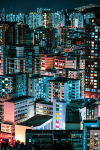 High angle view of illuminated buildings in city at night