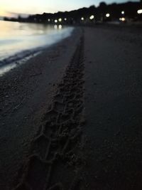 Surface level of road at beach against sky